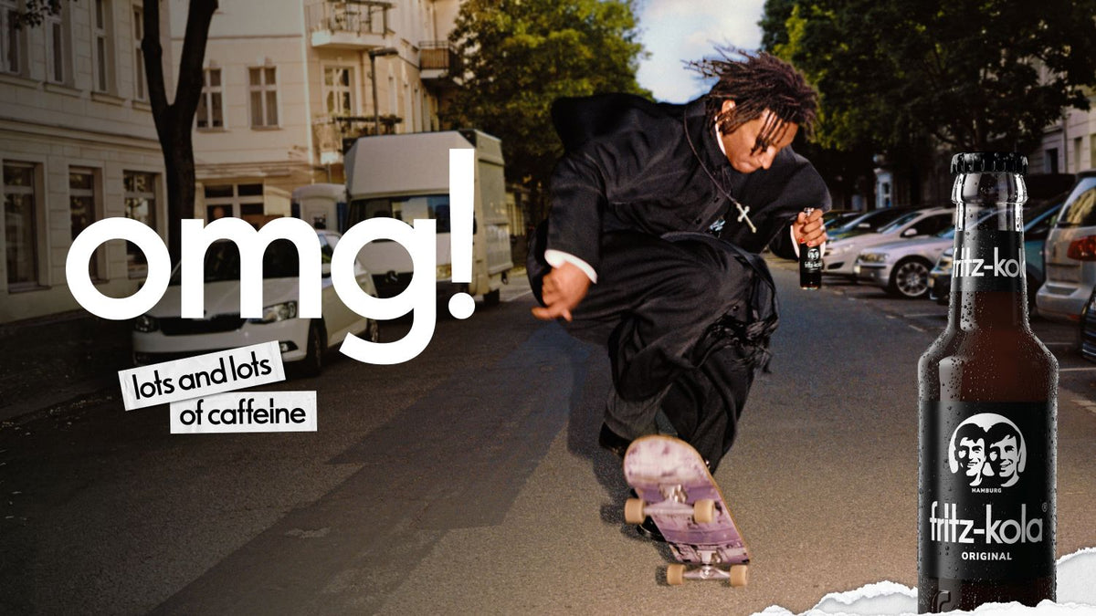 fritz-kola campaign featuring a skating priest performing a trick on a city street under the slogan “omg! lots and lots of caffeine”.