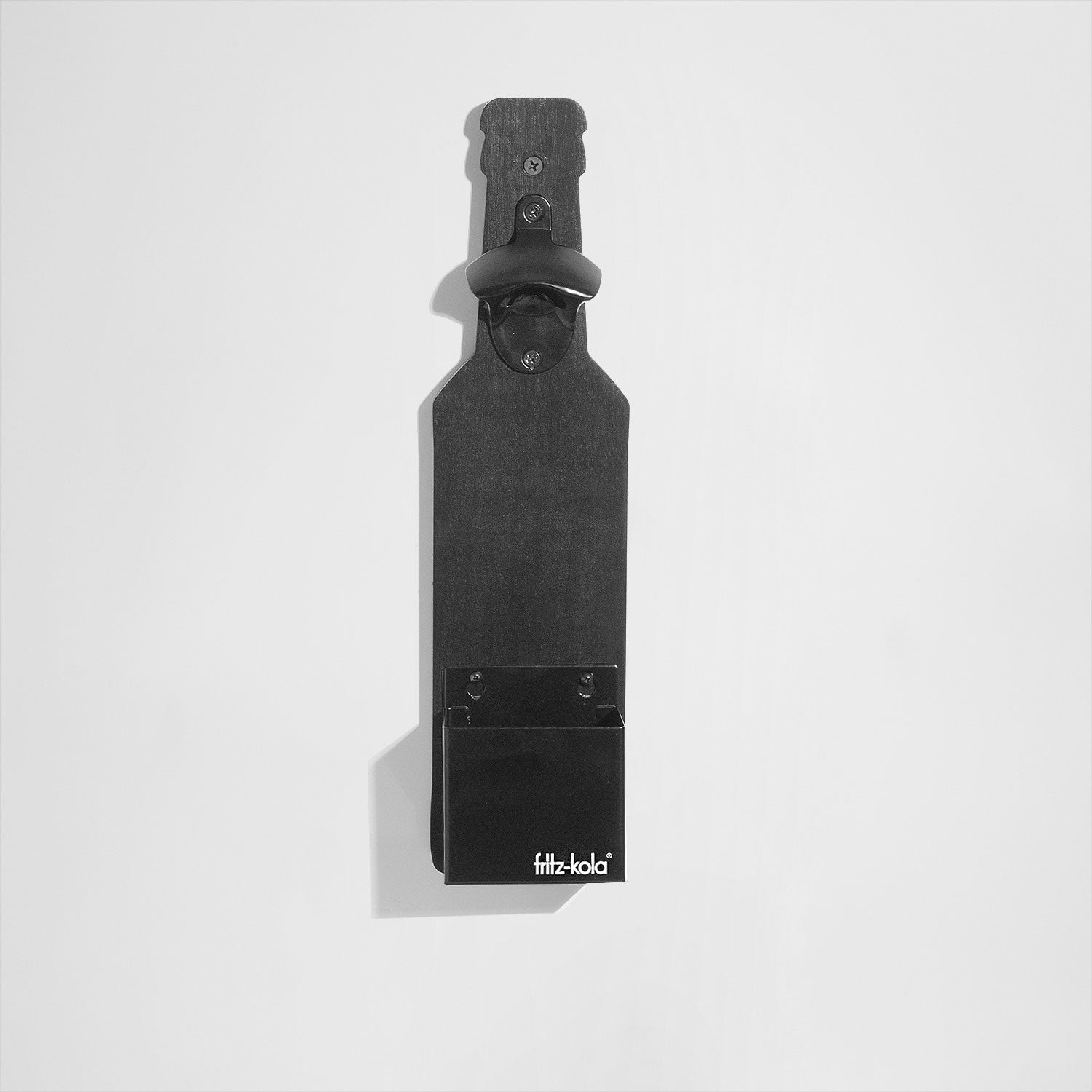 Wandflaschenöffner in Form einer fritz-kola Flasche vor hellem Hintergrund. 